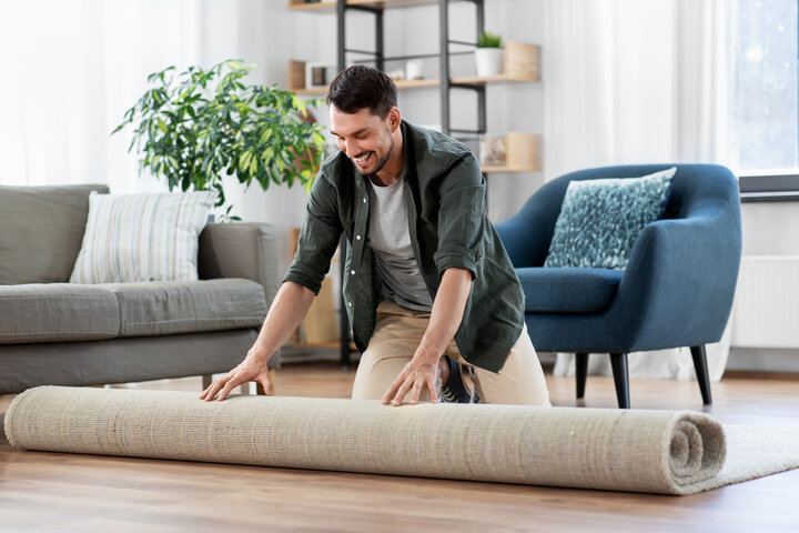 A person rolling a roll of carpet

AI-generated content may be incorrect.